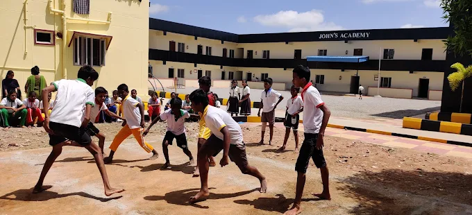 John's Academy students playing outdoor sports in the school grounds